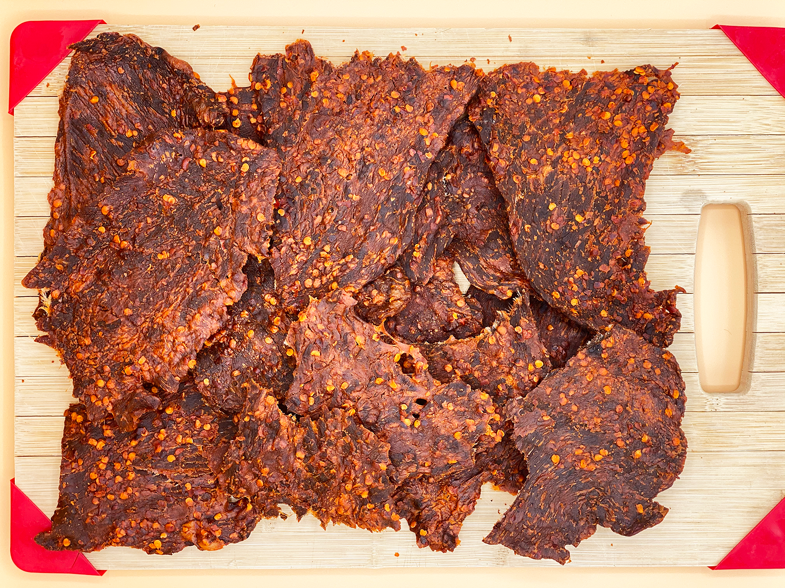 Dried beef jerky on a wooden cutting board